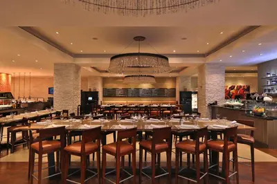 a dining room with a large table and chairs at InterContinental Costa Rica at Multiplaza Mall by IHG in San José