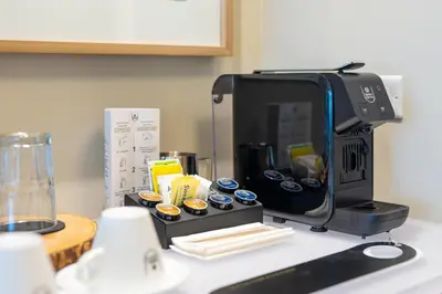 a kitchen counter with a coffee maker on a counter at InterContinental Costa Rica at Multiplaza Mall by IHG in San José