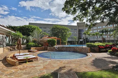a swimming pool in a courtyard with a building at InterContinental Costa Rica at Multiplaza Mall by IHG in San José