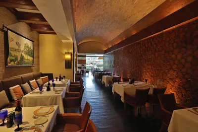 a dining room with tables and chairs in a restaurant at InterContinental Costa Rica at Multiplaza Mall by IHG in San José
