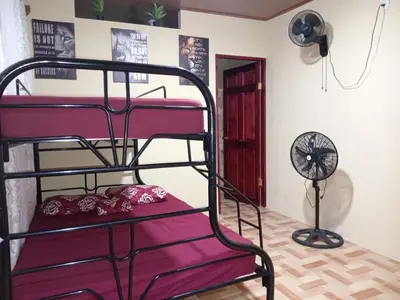 a room with two bunk beds and a fan at Nambí Rooms alojamiento no tradicional in Nambí