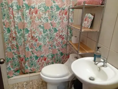 a bathroom with a toilet and a sink at Nambí Rooms alojamiento no tradicional in Nambí