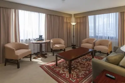 a living room with a couch and chairs and a table at Delta Hotels by Marriott San Jose Aurola in San José
