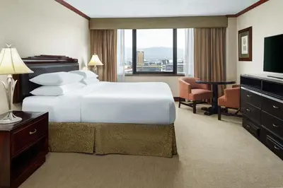 a hotel room with a large white bed and a desk at Delta Hotels by Marriott San Jose Aurola in San José