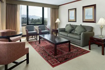 a living room with a couch and a table at Delta Hotels by Marriott San Jose Aurola in San José