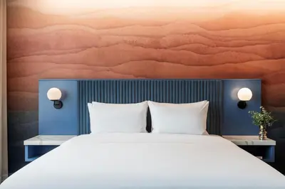 a bedroom with a large bed with a painting on the wall at Hyatt Centric San José Escazú in San José