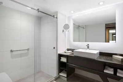 a bathroom with a sink and a mirror at Crowne Plaza San Jose La Sabana by IHG in San José