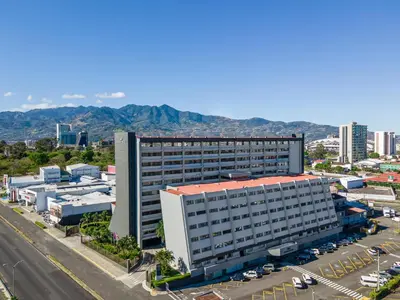 an overhead view of a large building with a parking lot at Crowne Plaza San Jose La Sabana by IHG in San José
