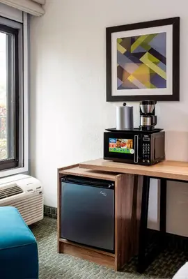 a room with a tv and a microwave on a table at Holiday Inn Express San Jose Costa Rica Airport by IHG in Alajuela City