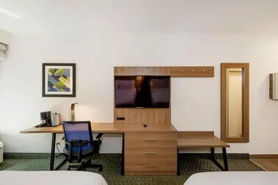 a room with a desk and a tv on a wall at Holiday Inn Express San Jose Costa Rica Airport by IHG in Alajuela City