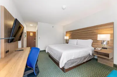 a hotel room with a bed and a desk and a television at Holiday Inn Express San Jose Costa Rica Airport by IHG in Alajuela City