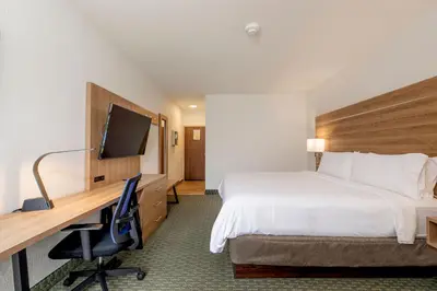 a hotel room with a bed and a desk with a computer at Holiday Inn Express San Jose Costa Rica Airport by IHG in Alajuela City