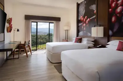 a hotel room with two beds and a balcony at Costa Rica Marriott Hotel Hacienda Belen in San José