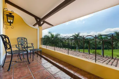 a balcony with two chairs and a view at Costa Rica Marriott Hotel Hacienda Belen in San José