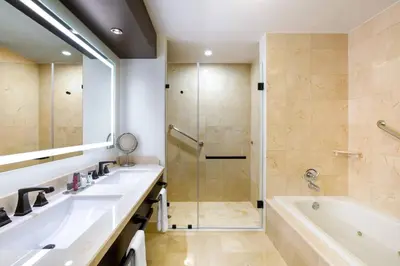 a bathroom with two sinks and a shower at Costa Rica Marriott Hotel Hacienda Belen in San José
