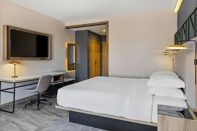 a hotel room with a bed and a desk at Courtyard by Marriott San Jose Escazu in San José