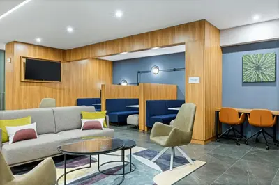 a waiting room with a couch and chairs and a table at Courtyard by Marriott San Jose Escazu in San José
