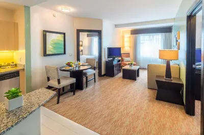 a hotel room with a living and dining room at Residence Inn by Marriott San Jose Escazu in San José