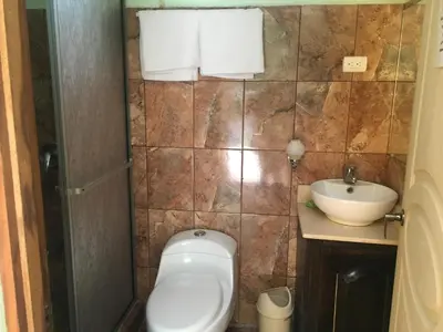 a bathroom with a toilet and a sink at Cabinas Brisas del Golfo in Colorado