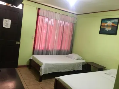 a small room with two beds and a window at Cabinas Brisas del Golfo in Colorado