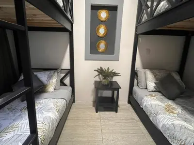 two sets of bunk beds in a room at Residencias Arenal in Fortuna
