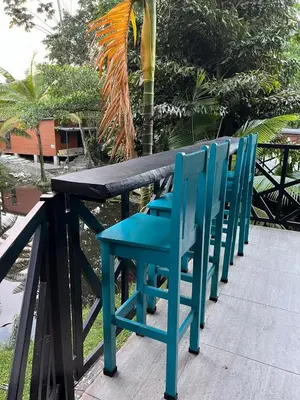 a group of blue chairs sitting at a table at Residencias Arenal in Fortuna