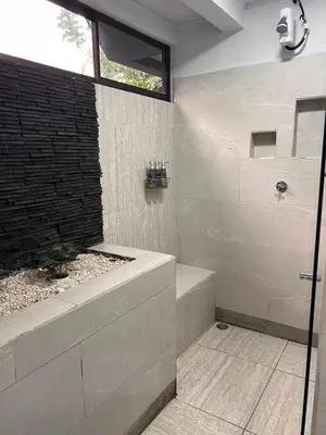 a bathroom with a shower with a glass door at Residencias Arenal in Fortuna
