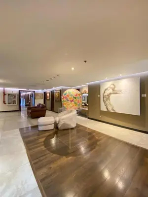 a large living room with a large painting on the wall at Studio Hotel Boutique in San José