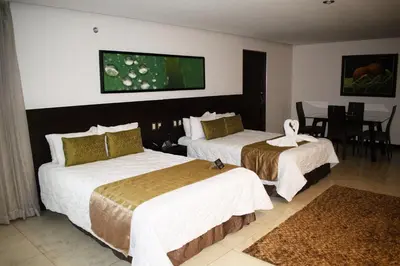 a hotel room with two beds and a table at Studio Hotel Boutique in San José