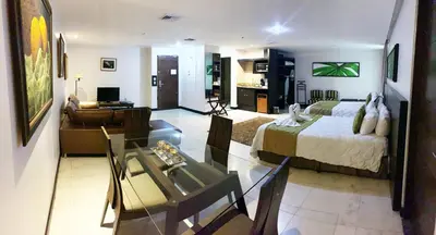 a bedroom with a bed and a living room at Studio Hotel Boutique in San José