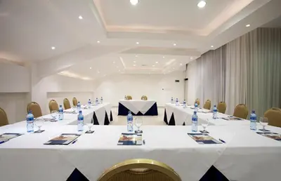 a conference room with a long table with bottles of water at Occidental Tamarindo - All Inclusive in Tamarindo