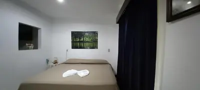 a bedroom with a bed with a white bow on it at Casa Mariana in Alajuela City