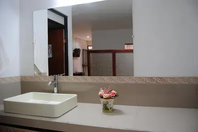 a bathroom with a white sink and a mirror at Casa Mariana in Alajuela City