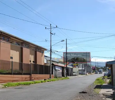 an empty street in a town with a building at Casa Mariana in Alajuela City