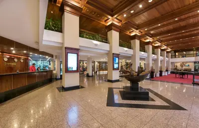 a lobby with a fountain in the middle of a building at Barceló San José in San José