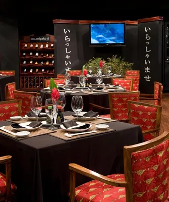 a table with wine glasses and napkins on it at Barceló San José in San José