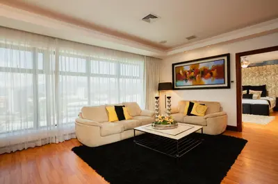 a living room with two couches and a table at Hotel Palma Real in San José