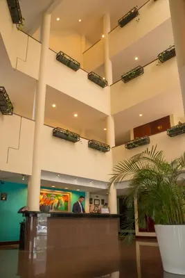 a man standing in the lobby of a hospital at Hotel Palma Real in San José