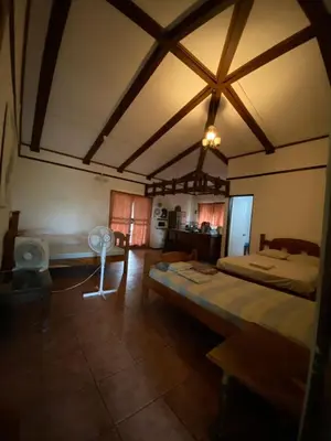 a large room with a bed and a table in it at Tiquisia Lodge in Curubandé