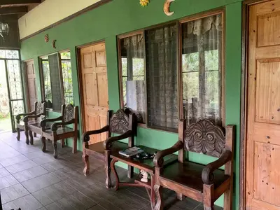 a room with four chairs and a table and windows at Tiquisia Lodge in Curubandé