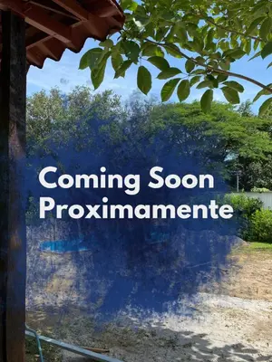 a sign that reads coming soon programmeline with a tree at Tiquisia Lodge in Curubandé