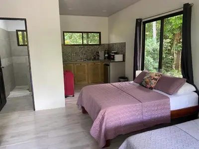 a bedroom with a bed and a walk in shower at Villas en el Bosque in Ojochal