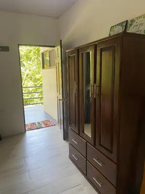 a large wooden cabinet in a room with a doorway at Villas en el Bosque in Ojochal