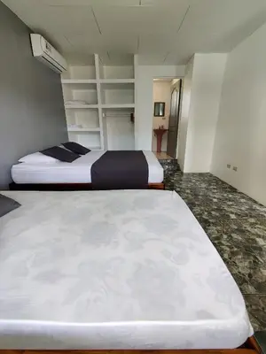 a bedroom with two beds in a room at Cabinas Maritza in Quebrada Ganado