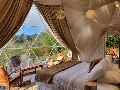 a bedroom with a bed and a large window at Quinta Esencia in Alajuela City