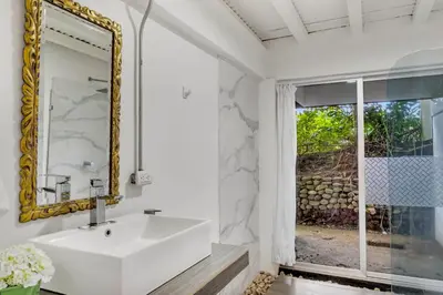 a bathroom with a white sink and a mirror at Quinta Esencia in Alajuela City