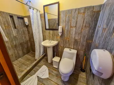 a bathroom with a toilet and a sink at Villas Fernanda in Fortuna