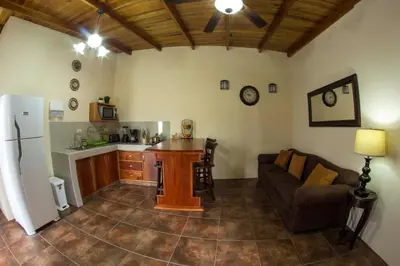 a kitchen and living room with a couch and a table at Villas Fernanda in Fortuna