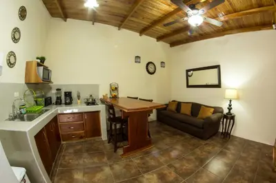 a kitchen with a table and a couch in a room at Villas Fernanda in Fortuna