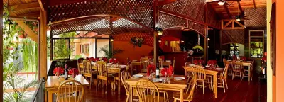 a restaurant with tables and chairs in a room at Villas Fernanda #2 in Fortuna